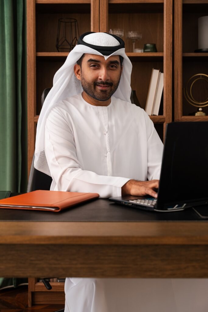 Middle-eastern emirati businessman wearing kandura working in the office